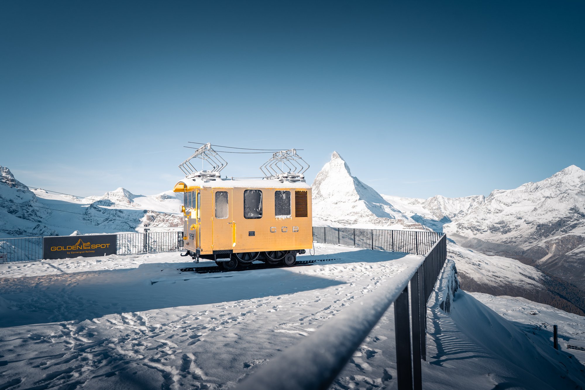 Goldene Lok der Gornergrat Bahn am Golden Spot auf dem Gornergrat, im Hintergrund das Matterhorn – Themenweg zum Jubiläum, gestaltet von Hü7